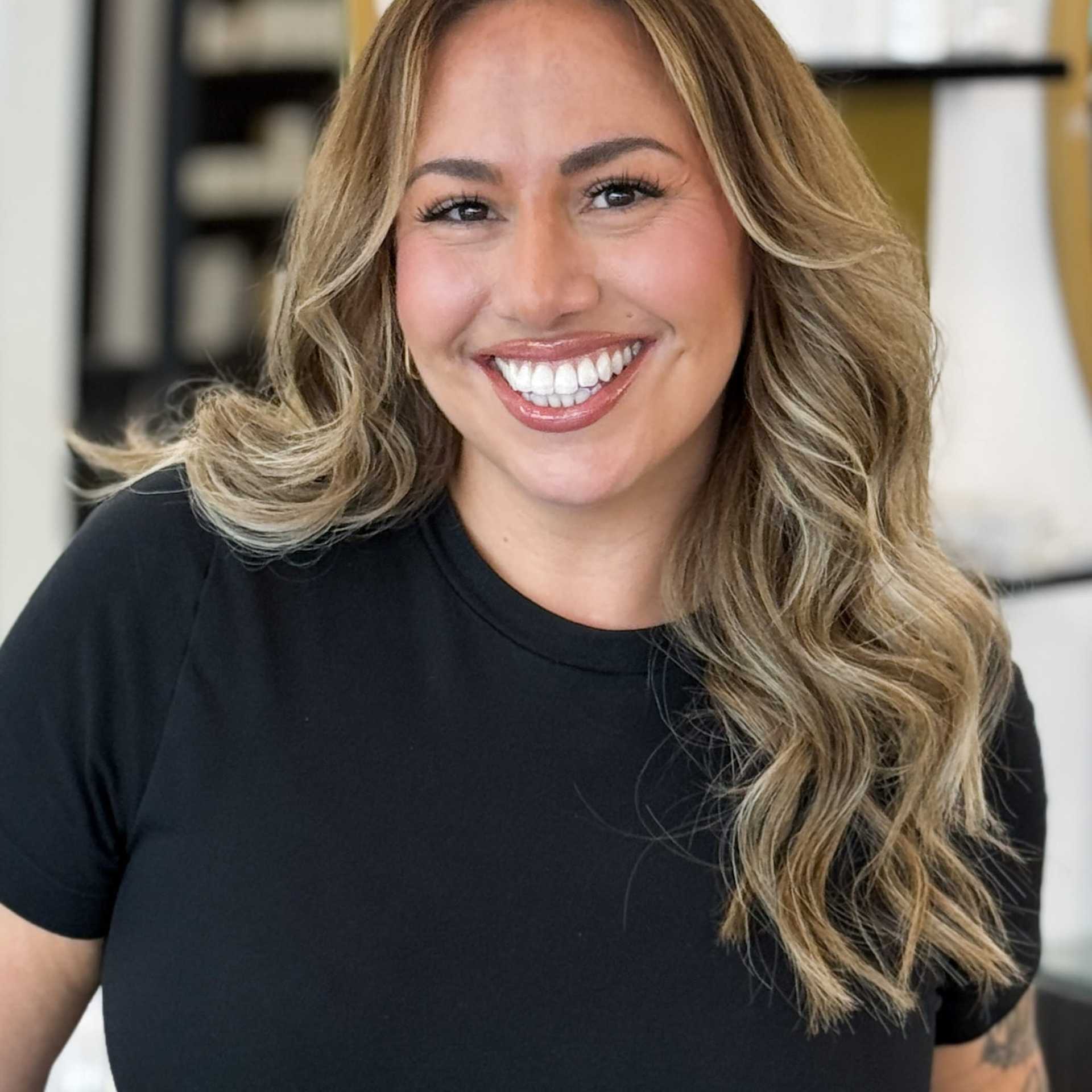 Portrait of CJ, a professional stylist at Salon Blissful Med Spa, showcasing their expertise and style.