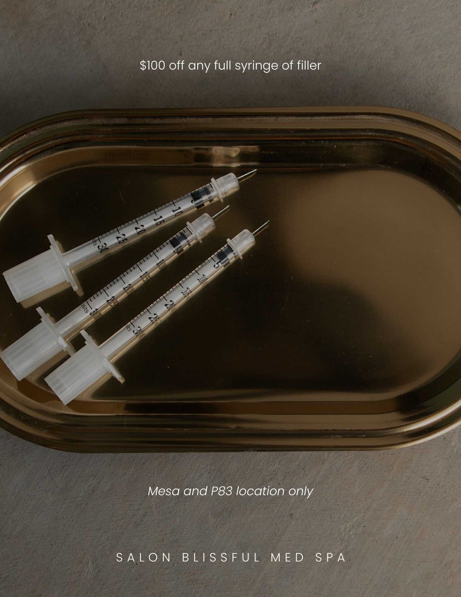 Three syringes on a tray. Text offers $100 off fillers at Salon Blissful Med Spa, Mesa, and P83.