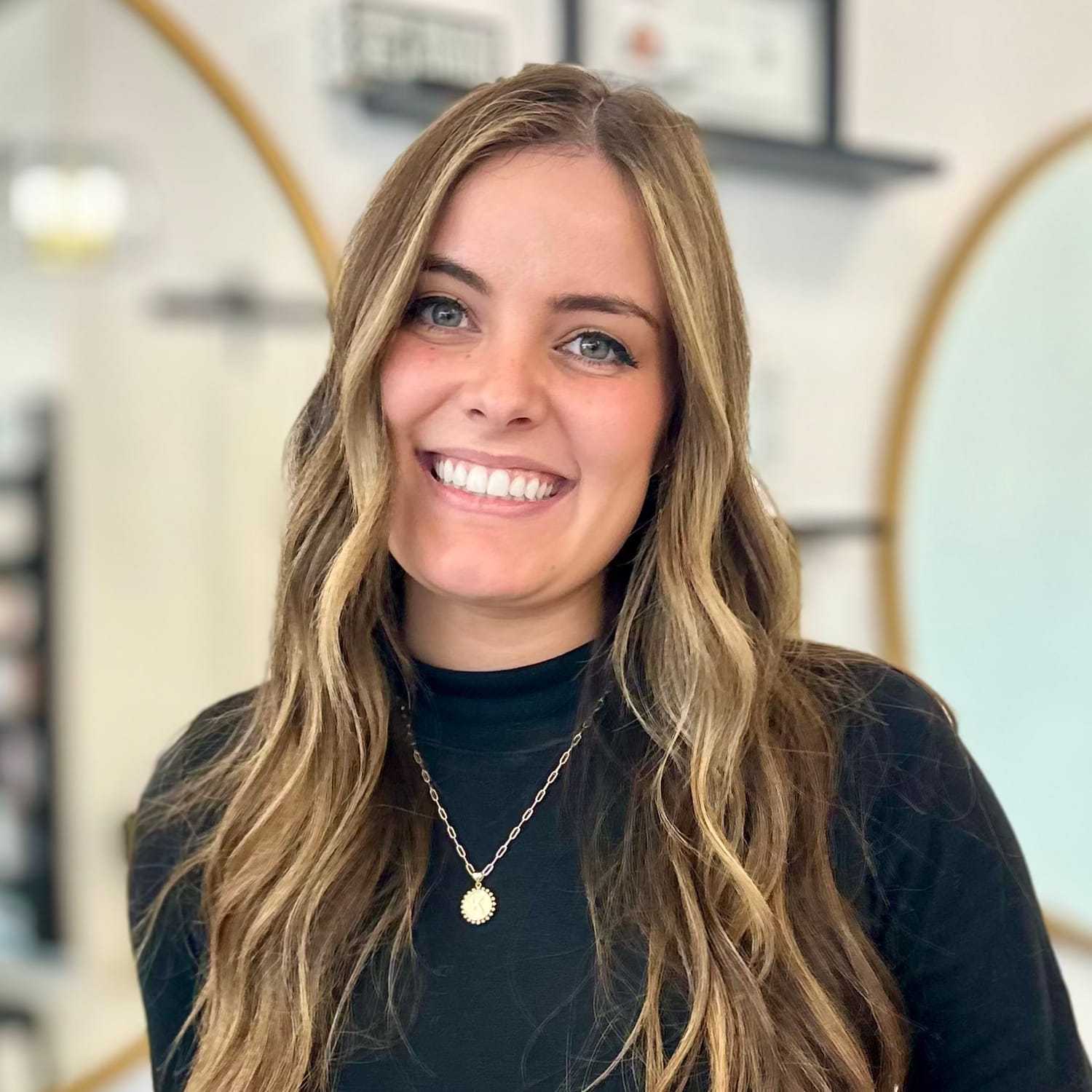 Portrait of Kamri, a professional stylist at Salon Blissful Med Spa, showcasing their expertise and style.