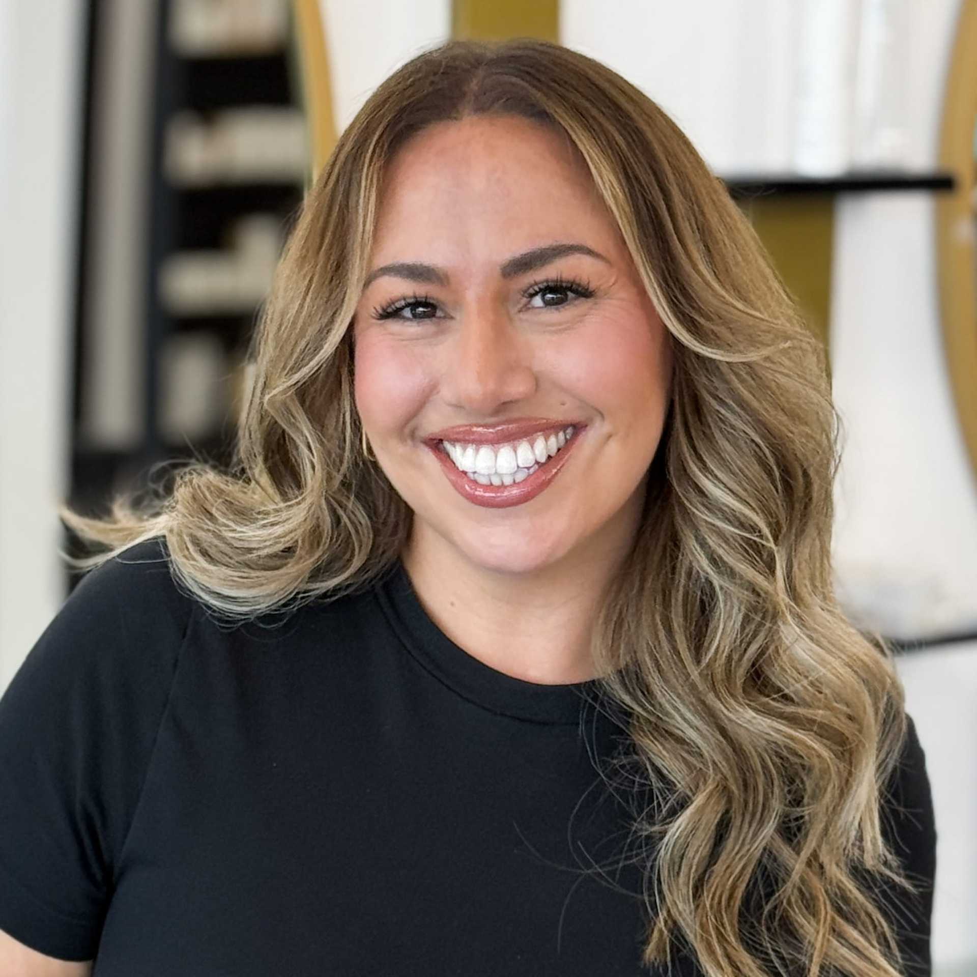 Portrait of CJ, a professional stylist at Salon Blissful Med Spa, showcasing their expertise and style.