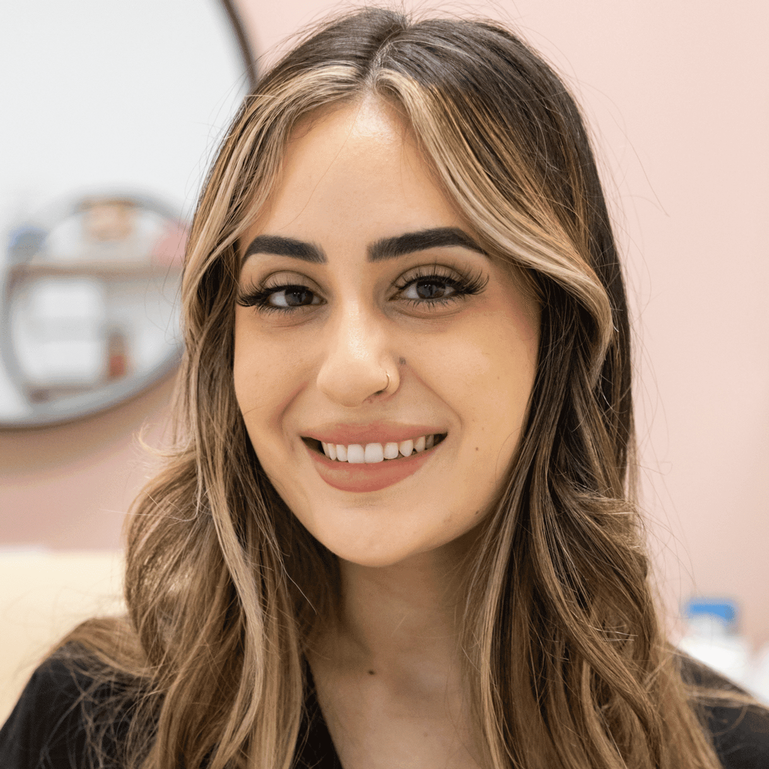 Portrait of Dalida, a professional stylist at Salon Blissful Med Spa, showcasing their expertise and style.