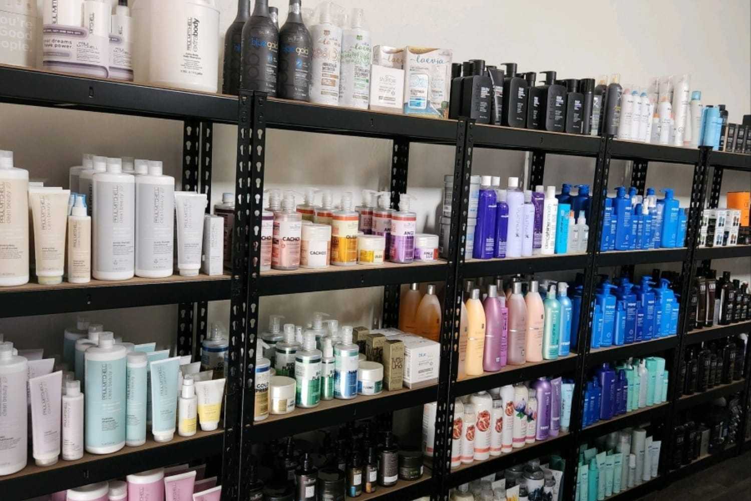 Shelves stocked with assorted hair care products in various bottles and colors.