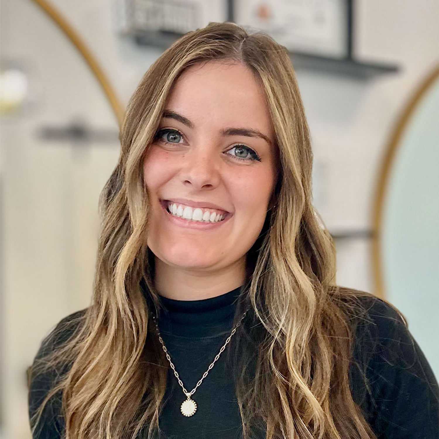 Portrait of Kamri, a professional stylist at Salon Blissful Med Spa, showcasing their expertise and style.